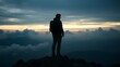 © adidesigner23 - Silhouette of a person with a backpack on rugged terrain at sunrise