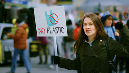 Save planet ecology protest outdoor. Activist person hold anti global warm banner. Eco demonstration placard. No climate change concept. City street picket background. World care rally Plastic poster