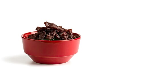 Poster - Dog treat Strips or sticks of dried meat in a red bowl White background Concept of dog food. Copy space image. Place for adding text and design