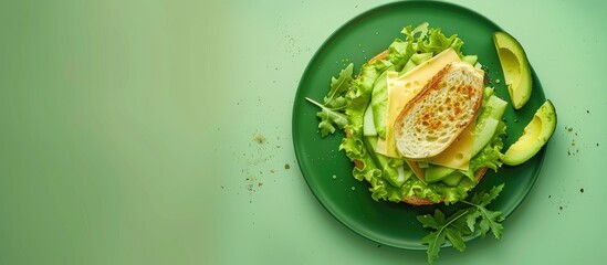 Canvas Print - Sandwiches featuring cheese avocado and lettuce on a green plate Breakfast idea Copyspace