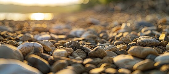 Poster - Selective focus on the foreground featuring numerous small stones with a blurred background of additional stones Copy space available for use