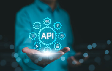 API, Application Programming Interface Concept. A person presents a glowing API (Application Programming Interface) concept surrounded by digital icons. technology and networking elements.