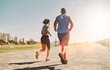 © SunriseDon/peopleimages.com - City, running back of couple for fitness, physical health and training for marathon as team. Flare, man and woman with resilience for exercise session, cardio and wellness with endurance on promenade
