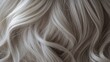 © Prostock-studio - Soft silver blonde hair with gentle waves displays a lustrous texture, inviting a sense of elegance and style.