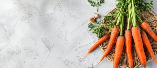 Poster - Fresh carrots and a wicker mat on a white grunge backdrop. Copy space image. Place for adding text and design