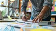 © Erd.Concept - Man Working on Paperwork at a Desk