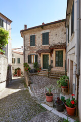 Sticker - A street between old houses in Carovilli, a village in Molise in Italy.