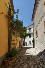 Sticker - A street between old houses in Carovilli, a village in Molise in Italy.