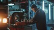 © VK Studio - A mechanic in a beanie, illuminated by cool workshop lights, concentrates on repairing part of a large truck.
