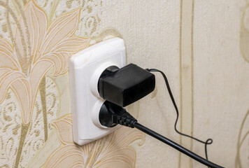 socket on the wall. Double socket, two plugs inside it