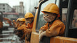 © Natalia - Cats in construction helmets and work outfits on construction vehicles at an urban worksite.