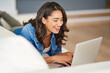 © C.Arcurs/peopleimages.com - Laptop, happy woman and laughing in home for funny blog, comedy movie or streaming show to relax on sofa. Computer, smile or girl online for meme, reading joke or watch video on social media platform