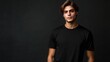 © 69 - Young man modeling a blank black T-shirt, ideal for advertising or presentation of branding concepts with ample copy space.