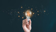 © Pongsak - Hand holding the light bulb with a technological network cable connected to it.