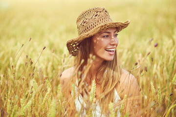 Canvas Print - Smile, woman and thinking in wheat field for peace, growth and environment care in nature. Happy, relax and person in grain farm for agriculture, calm and positive mental health in summer with hat