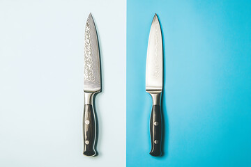 Wall Mural - Two kitchen knives displayed on contrasting backgrounds for comparison.