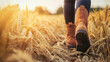 © Andres Mejia - Farmer walking through a golden wheat field at sunset