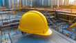 © Andres Mejia - Yellow hard hat sitting on construction site with city in background