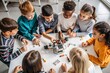 © hobonski - Young Students Engage in Robotics Learning. A group of enthusiastic children, ranging from diverse ethnic backgrounds, gather around a table in a classroom setting.
