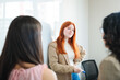 © padnob - Smiling businesswoman sharing business ideas with colleagues during a collaborative meeting on the whiteboard at office