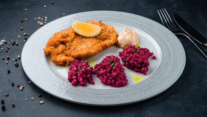 Canvas Print - Fried pork fillet with rice in beetroot sauce.