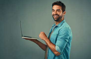 Fototapete - Studio, portrait and business man with laptop for research, planning and access information on internet. professional career, connect and web designer for online, software update and gray background