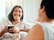 © KayJoint/peopleimages.com - Woman, happy and coffee on sofa with mother, bonding and laugh at funny story at home. Mom, daughter or smile in living room for tea time, reunion or relationship development by sharing good memories