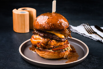 Poster - American food burger with chicken, pork, cabbage, cheddar cheese, pickled cucumbers, tomatoes and sauce.