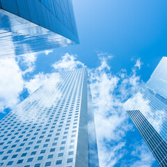 Looking Up  modern high-rise office buildings with blue sky in the background. 