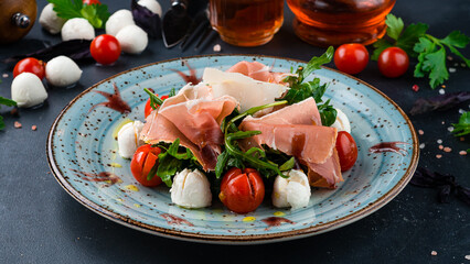 Canvas Print - Lunch salad with cherry tomatoes, mozzarella cheese, arugula, bacon and parmesan.