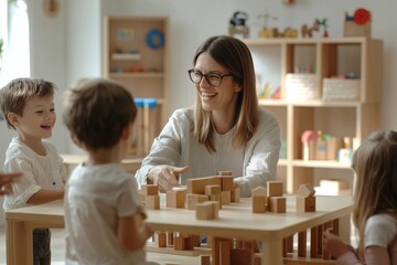 Wall Mural - Photo of A teacher playing with children in the kindergarten surrounded by wooden blocks and building blocks on tables laughing together. The background is white walls and light wood furniture.