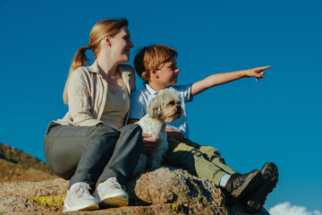 Canvas Print - Mother and son with shih tzu dog portrait in mountains