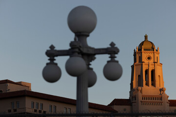 Wall Mural - Pasadena, California, USA - August 18, 2024: Sunset light shines on the historic downtown skyline and street lamps.