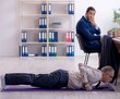 © Elnur - Two employees doing physical exercises at workplace