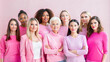 © LenaLensLife - Diverse group of women in pink outfits, breast cancer awareness concept on light pink background