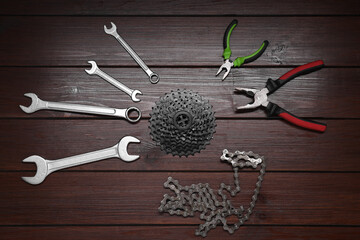 Sticker - Wrenches, pliers, bicycle cassette and chain on wooden background, flat lay