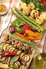 Wall Mural - Delicious grilled vegetables and spices served on table, flat lay