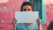 © Yada - Woman Holding Blank White Paper in Front of Face.