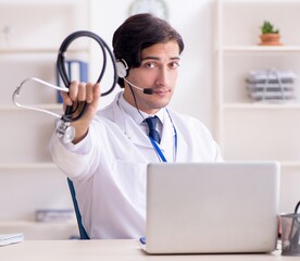 Wall Mural - Young male doctor in telemedicine concept