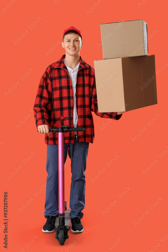 Male courier with big cardboard boxes and kick scooter on orange background