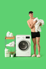 Poster - Young man in underpants with dirty laundry and washing machine on green background