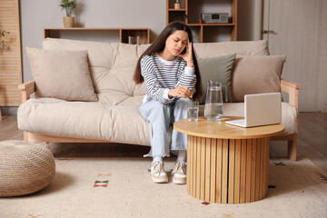 Sticker - Young woman with glass of water and soluble tablet suffering from headache at home