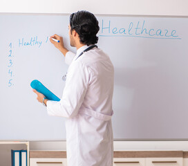 Wall Mural - Young doctor in front of whiteboard