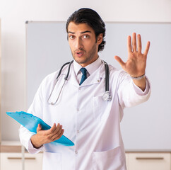 Wall Mural - Young doctor in front of whiteboard