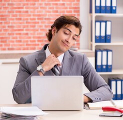 Wall Mural - Young businessman working in the office