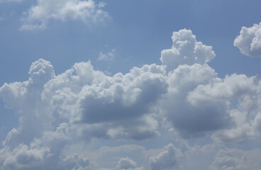 Canvas Print - a blue sky with puffy clouds.