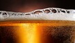 © intricateflow - Closeup view of a glass of beer with foam in front of a black background; a glass of beer in focus with beer foam on the top; beer and liquor; bar and pub; drink photography