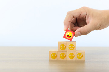 Poster - Hand choose wooden block with customer service smile face icon for best excellent satisfaction survey feedback for business review rating or finance digital marketing poll or user comment concepts.