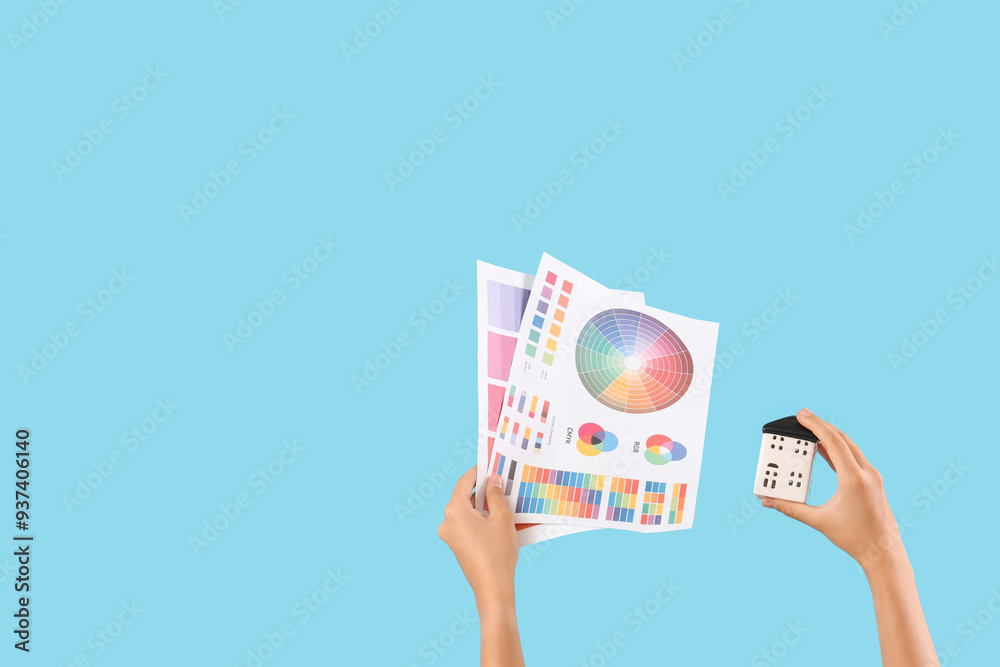 Architect with house figure and paint color palettes on blue background