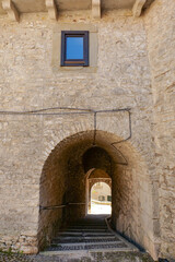 Poster - A street between old houses in Vastogirardi, a village in Molise in Italy.